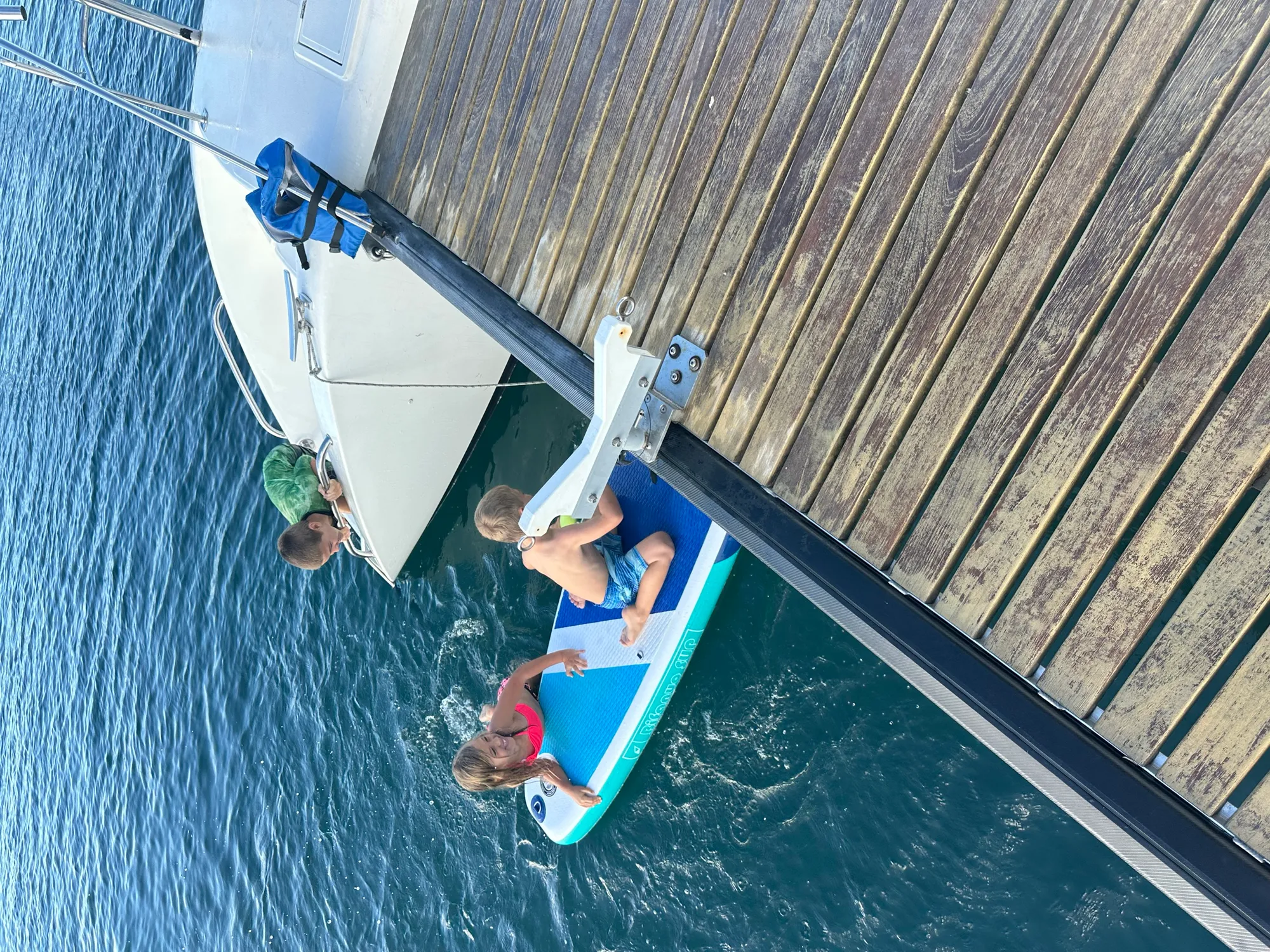 Aerial drone shot of a Voyage 500 catamaran sailing through clear turquoise Caribbean waters