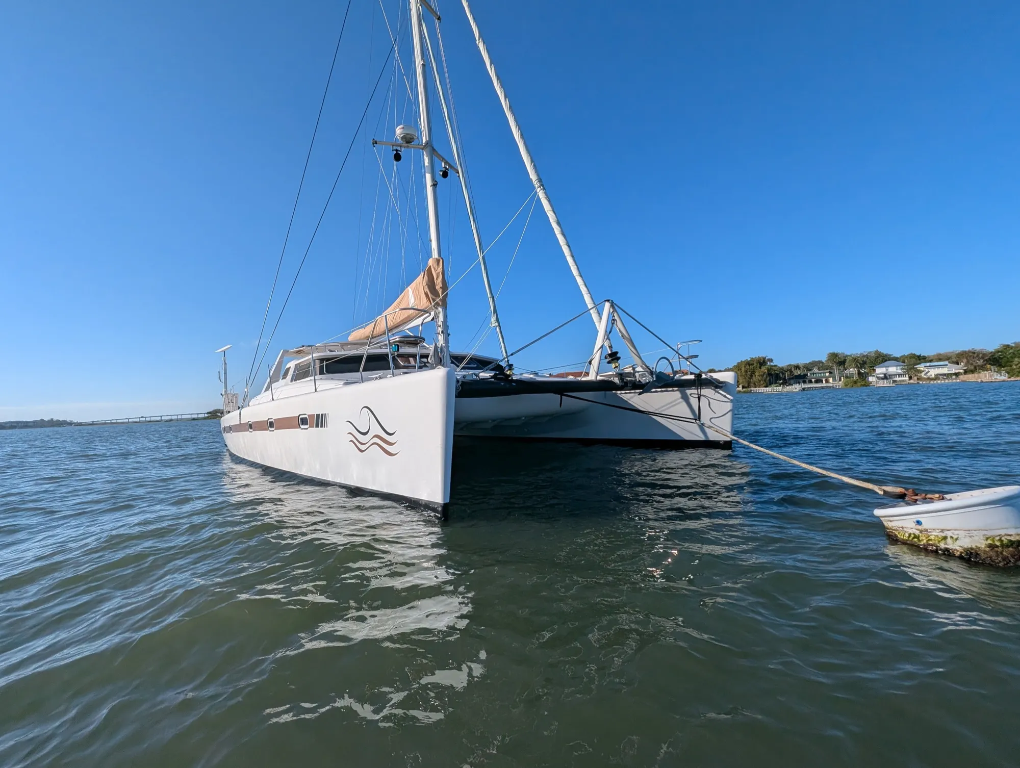 Voyage 500 catamaran full profile view on calm water showing twin hulls and flybridge