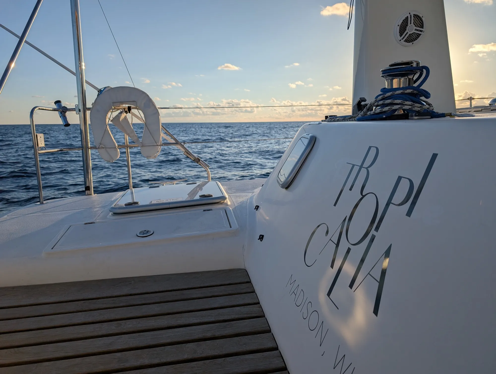 Stern of the Voyage 500 catamaran displaying the name Tropicalia with swim platform and tropical water below